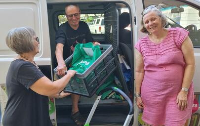 Volunteers taking books out of the library van.