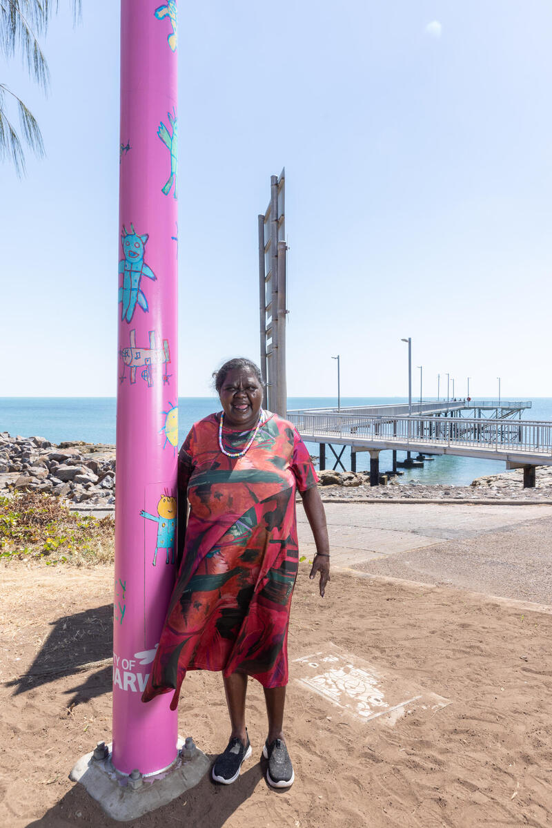 Artist Tara Darcy standing next to her Light pole artwork