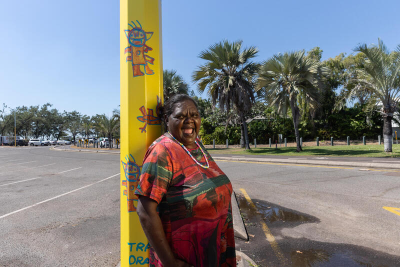 Artist Tara Darcy standing next to her Light pole artwork
