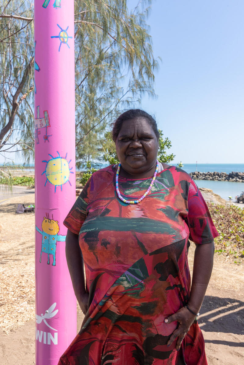 Artist Tara Darcy standing next to her Light pole artwork