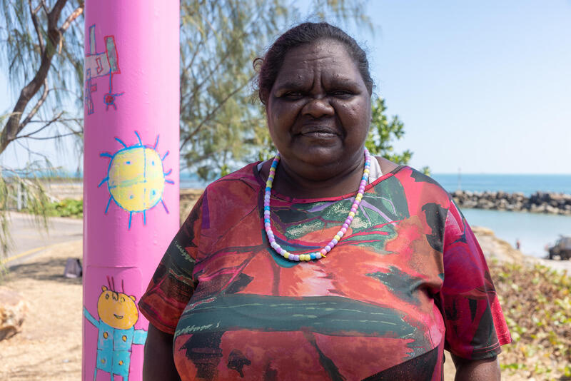 Artist Tara Darcy standing next to her Light pole artwork