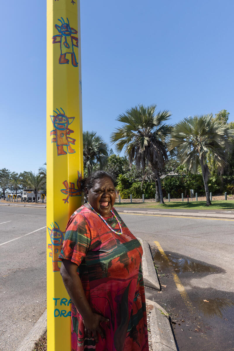 Artist Tara Darcy standing next to her Light pole artwork