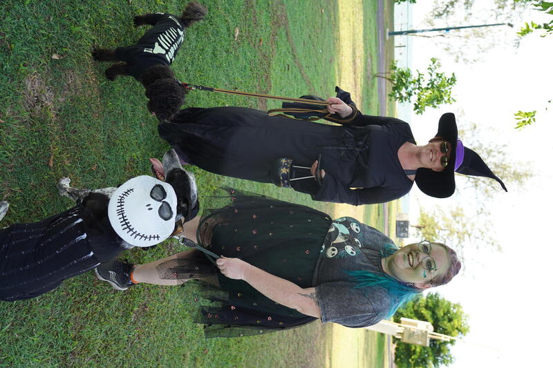 Jess, and her friend dressed as witches with her dog Chief dressed as Jack Skellington, The Nightmare before Christmas