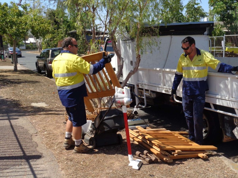 Council workers collection pre cyclone clean up items on a verge