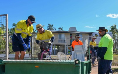 Council workers loading rubbish into trailer 