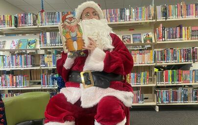 image of Santa reading a book for story time