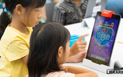 image of two children playing on iPad