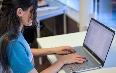 young woman typing on laptop