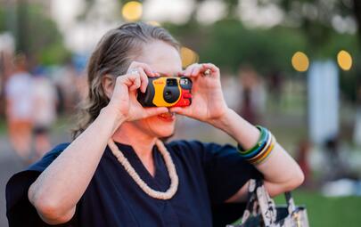 Girl holding disposable camera
