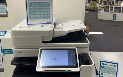 person putting page in scanner
