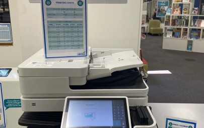 person putting page in scanner