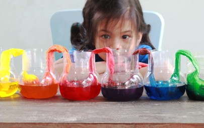 Young girl watching a colour rainbow science experiment