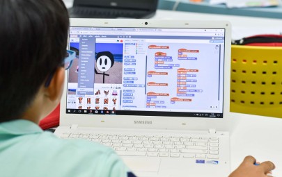 Boy using a computer coding program
