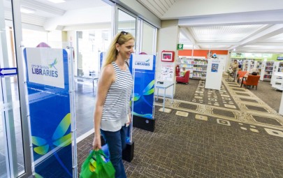 Lady walking into library with shopping bags