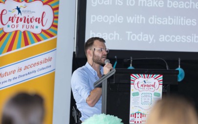 Man on stage speaking into microphone