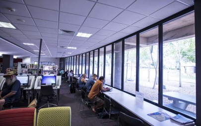 People looking out the window at the library