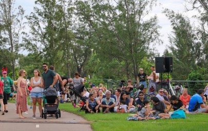 Crowd sitting on the grass at an event