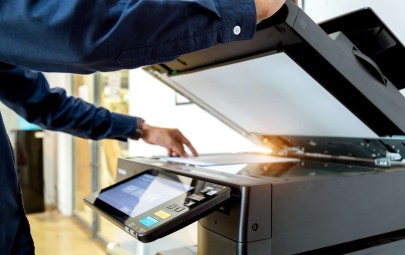 person putting page in scanner