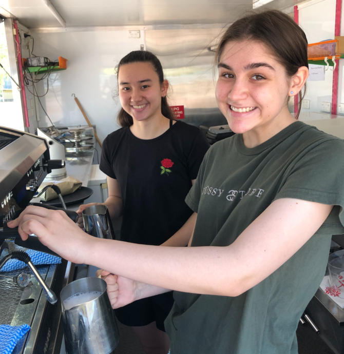 young people learning to use a coffee machine