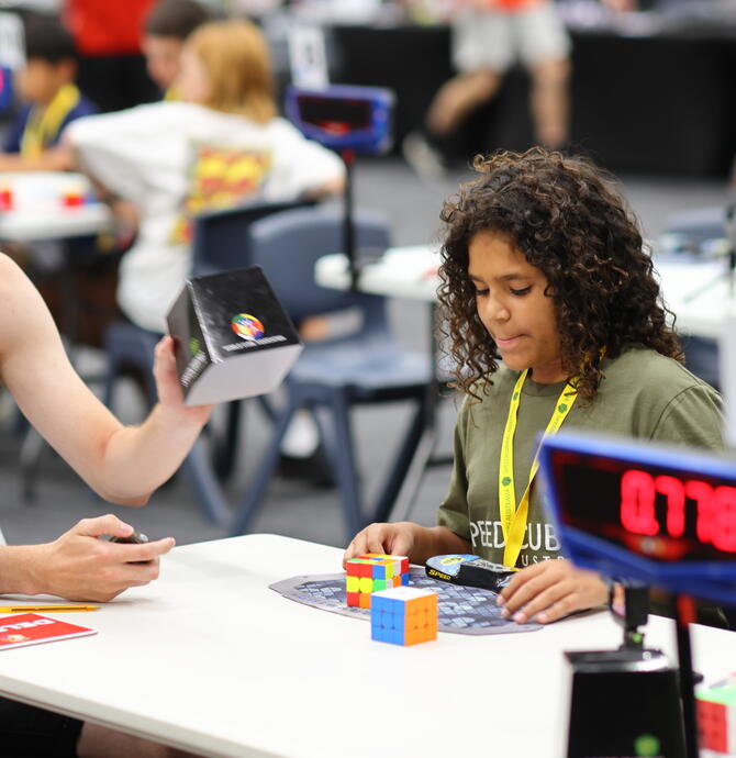 Young person competing in speedcubing event