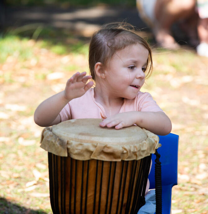 child playing on bongo drums