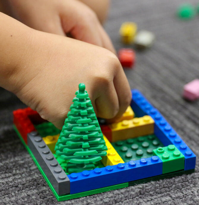 hands playing with lego