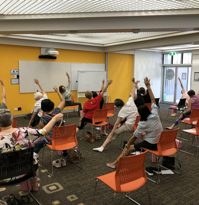 group of people enjoying chair yoga