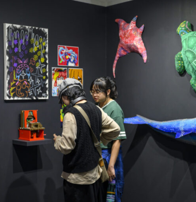young people looking at art exhibition