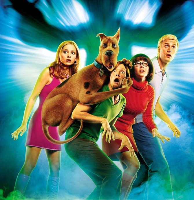 Poster for Scooby Doo - 4 young people looking scared and scooby doo climbing on Shaggy
