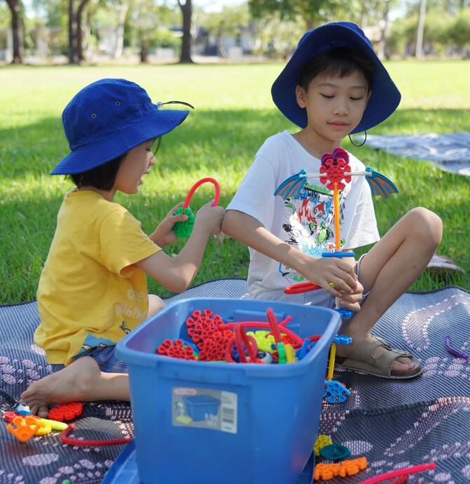 image to two siblings playing with toys