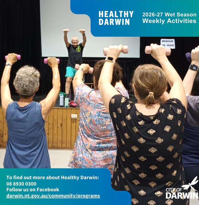 social media tile - instructor leading a zumba class from a raised platform, using light hand weights