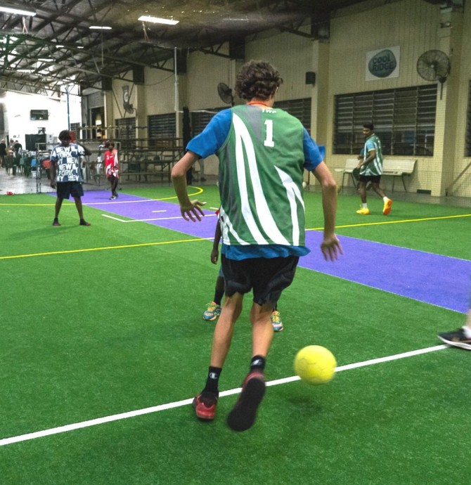 young people playing indoor soccer
