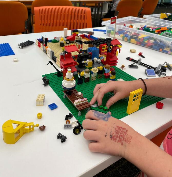 image of person playing with lego