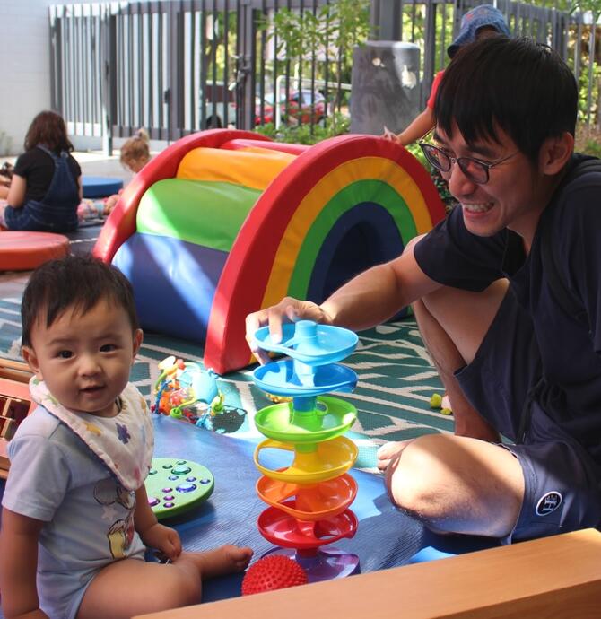 Baby and father playing together