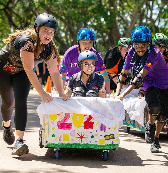 Young people racing couches at Couch Surfing 2025