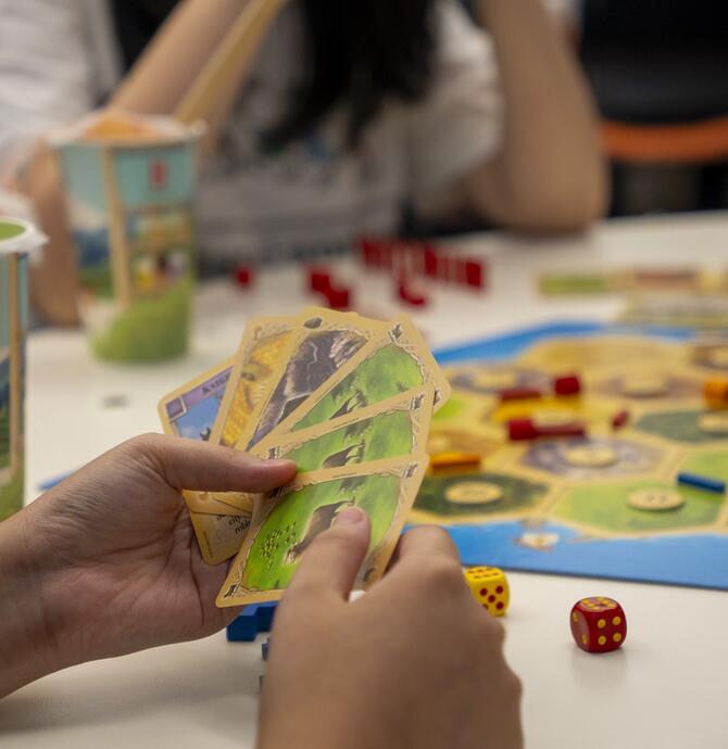 young people playing board games