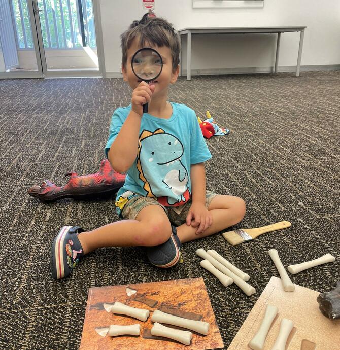 image of a child looking through a magnifying glass