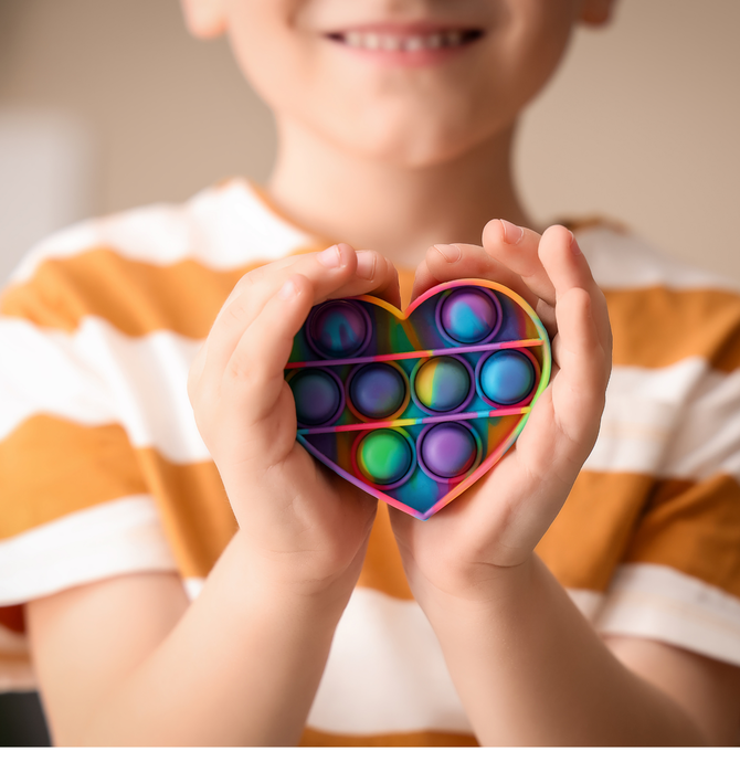 child with heart shaped item