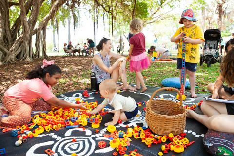 Kids playing with blocks outside in park