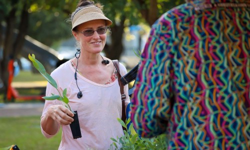 Lady holding native plant.