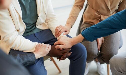 image of several hands linking